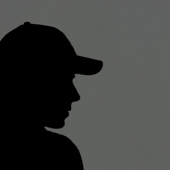 A file news photo of a person wearing a baseball cap in silhouette